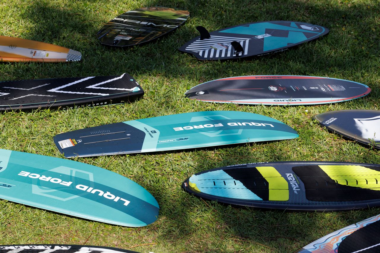 11 watersports boards laying on the grass